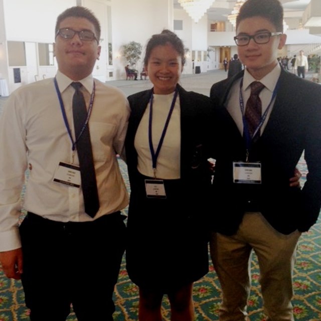 Three students at the DECA conference share laughs and smiles.